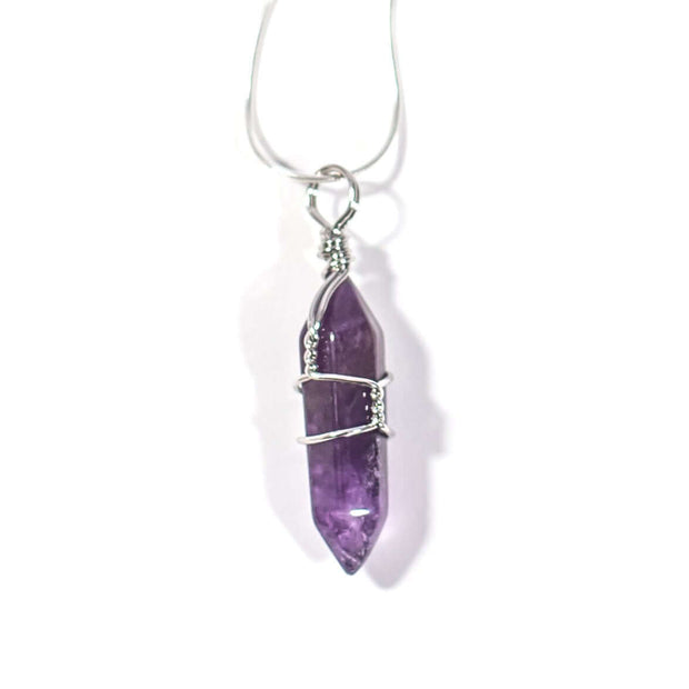 Dark purple Amethyst crystal pendant wrapped in silver tone stainless steel  with chain.