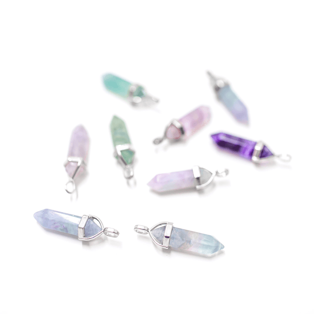scattered fluorite pendants displaying array of colours. purple green turquoise pink clear pendants