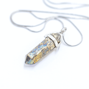 Close up of Gold and multicoloured pyrite meaning bullet point crystal  pendant complete with stainless steel chain
