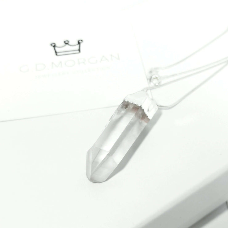 head on view of clear quartz natural crystal healing bullet with silver tone stainless steel snake chain.