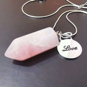 Natural rose quartz pink crystal pendant with sterling silver round love charm and stainless steel snake chain.