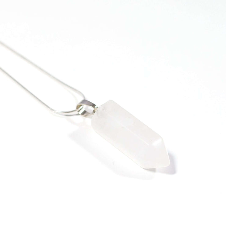 Close up view of Clear quartz pendant with snake chain.