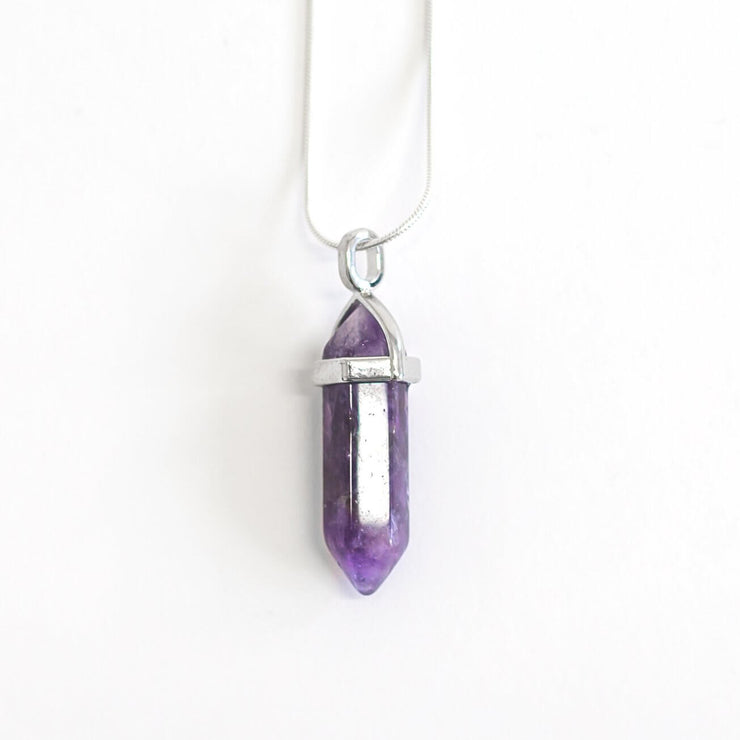 Head on view of purple amethyst meaning point with snake chain