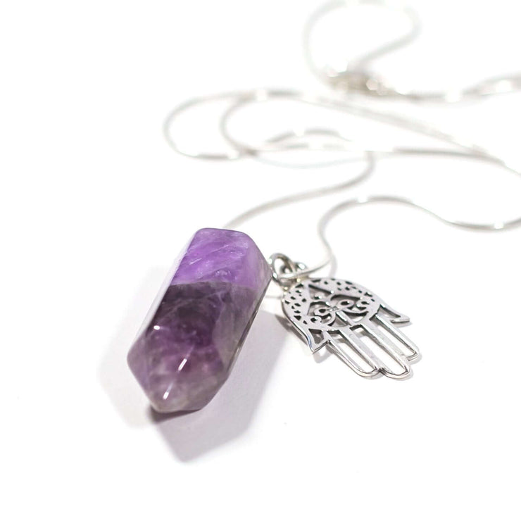 Close up of Purple relaxation natural crystal Amethyst bullet  with Hamsa hand charm.
