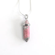 Compassion and balance Rhodonite crystal pendant head on. 