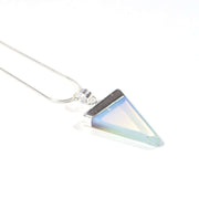 Close up of triangular opal crystal pendant with stainless steel chain.