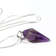Side view of Amethyst oval pendulum pendant with stainless steel snake chain.