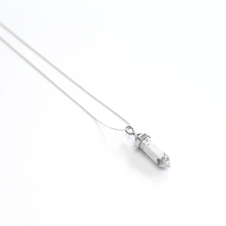 Long view of white howlite natural crystal pendant .