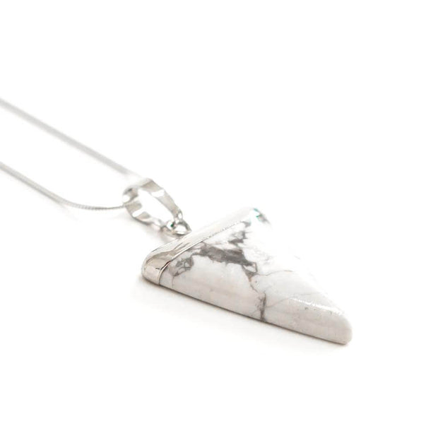 Side view of Crystal Howlite Triangle shape pendant necklace with silver tone snake chain.