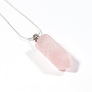 Close up view of Rose Quartz Love and compassion bullet pendant and steel chain.