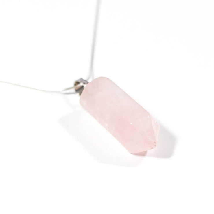 Close up view of Love Rose Quartz crystal pendant and snake chain.