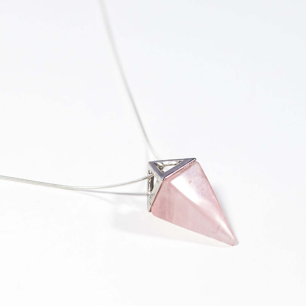 Side view of Natural Love crystal Rose Quartz pyramid necklace with silver tone snake chain.